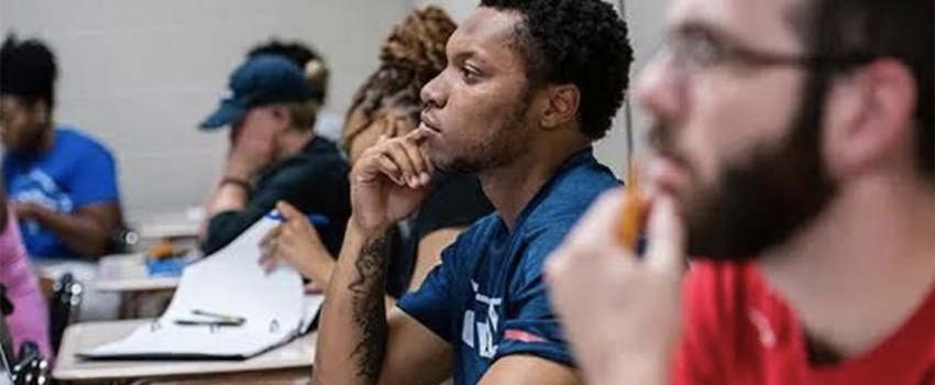 Students listening in class sitting in desks.